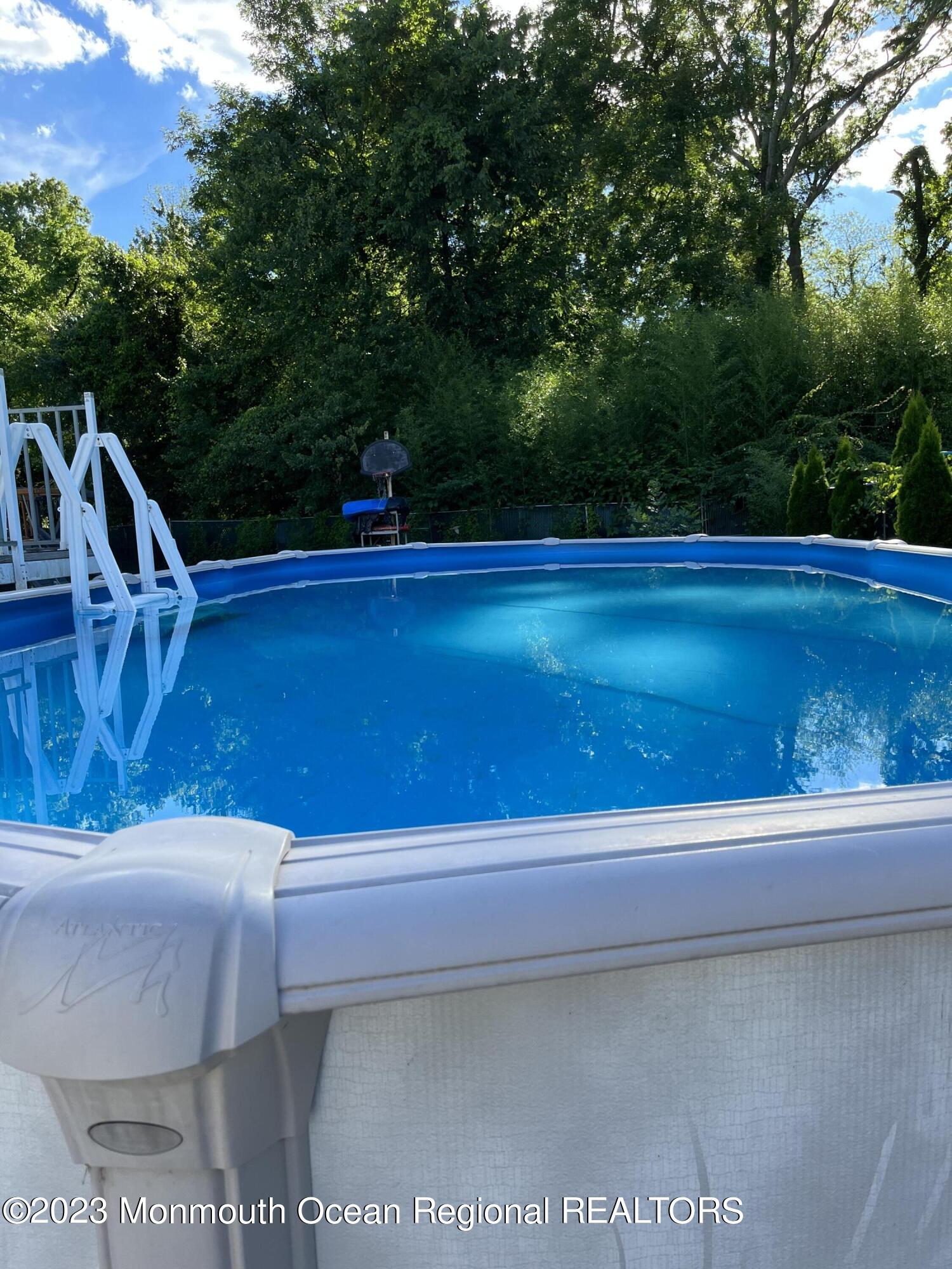 42 Epping Drive Kenilworth, NJ 07033 - Photo 22 of 22 a view of backyard with swimming pool and outdoor seating