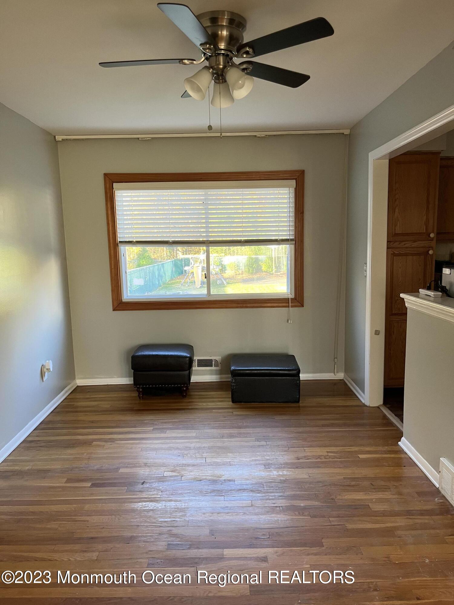 42 Epping Drive Kenilworth, NJ 07033 - Photo 4 of 22 an empty room with wooden floor and windows