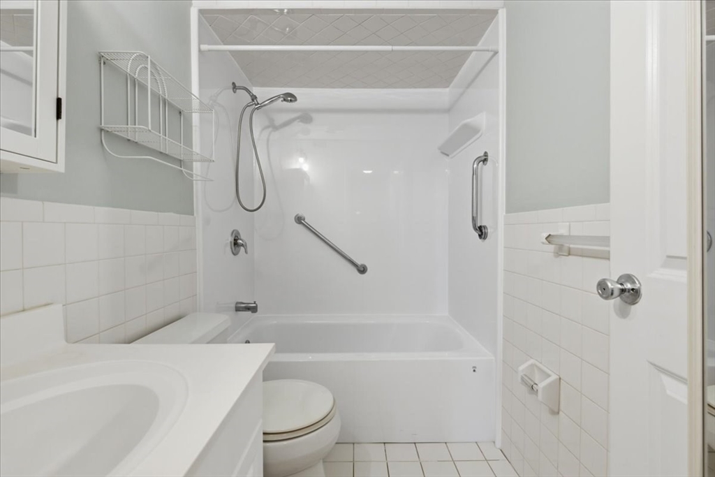 360 Neponset Street, Unit 702 Canton, MA 02021 - Photo 15 of 21 a bathroom with a granite countertop bathtub shower sink vanity and toilet