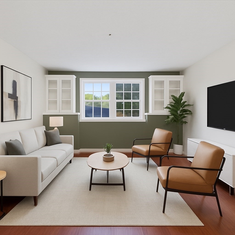 360 Neponset Street, Unit 702 Canton, MA 02021 - Photo 5 of 21 a living room with furniture and a flat screen tv