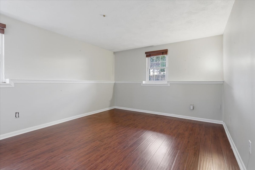360 Neponset Street, Unit 702 Canton, MA 02021 - Photo 9 of 21 an empty room with wooden floor and window