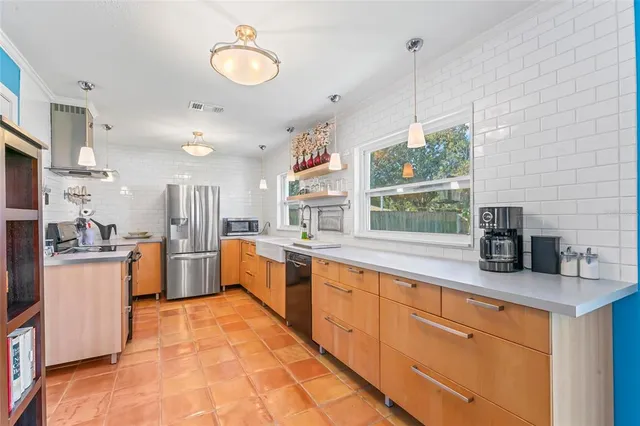 a kitchen with stainless steel appliances granite countertop a stove and a sink
