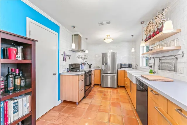 a kitchen with stainless steel appliances granite countertop a sink and cabinets