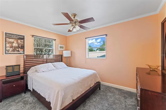 a bedroom with a large bed and a window