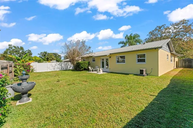 a view of a backyard with plants and a garden
