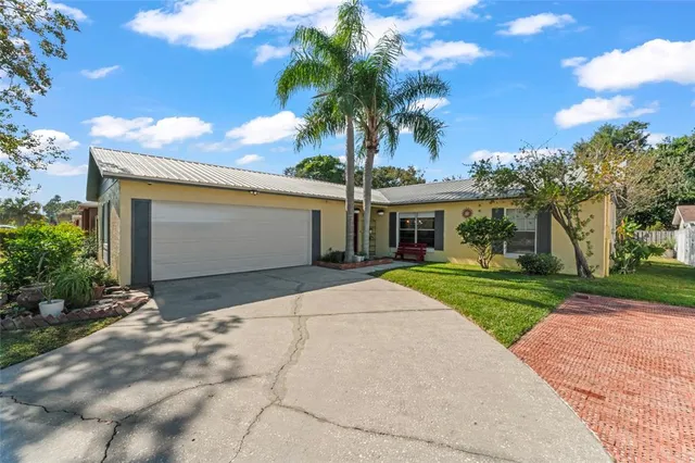 a aerial view of a house with a yard and potted plants