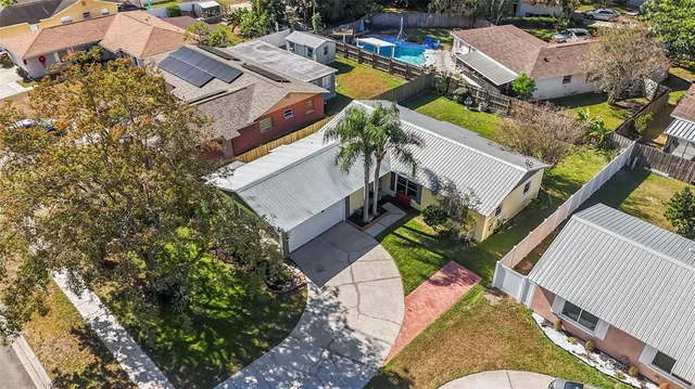 an aerial view of a house with a yard