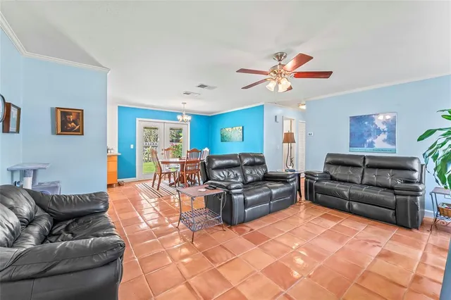 a living room with furniture ceiling fan and a rug