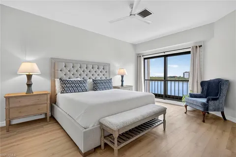 a bedroom with a bed window and a table