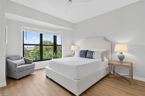 a bedroom with a large bed and a large window