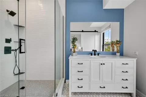 a bathroom with a sink vanity and mirror