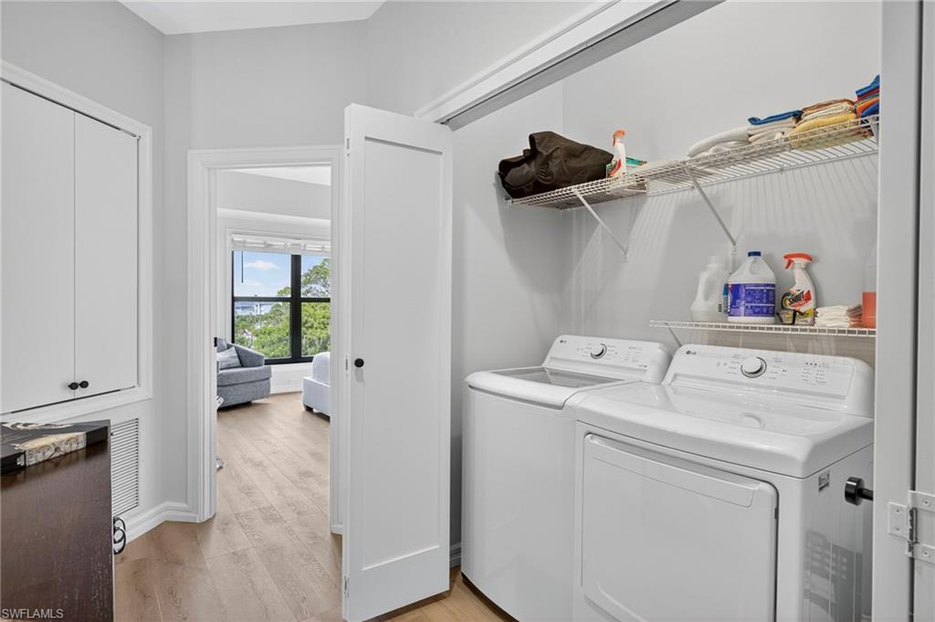 111 La Peninsula Boulevard, Unit 111 Naples, FL 34113 - Photo 27 of 33 a utility room with dryer and washer