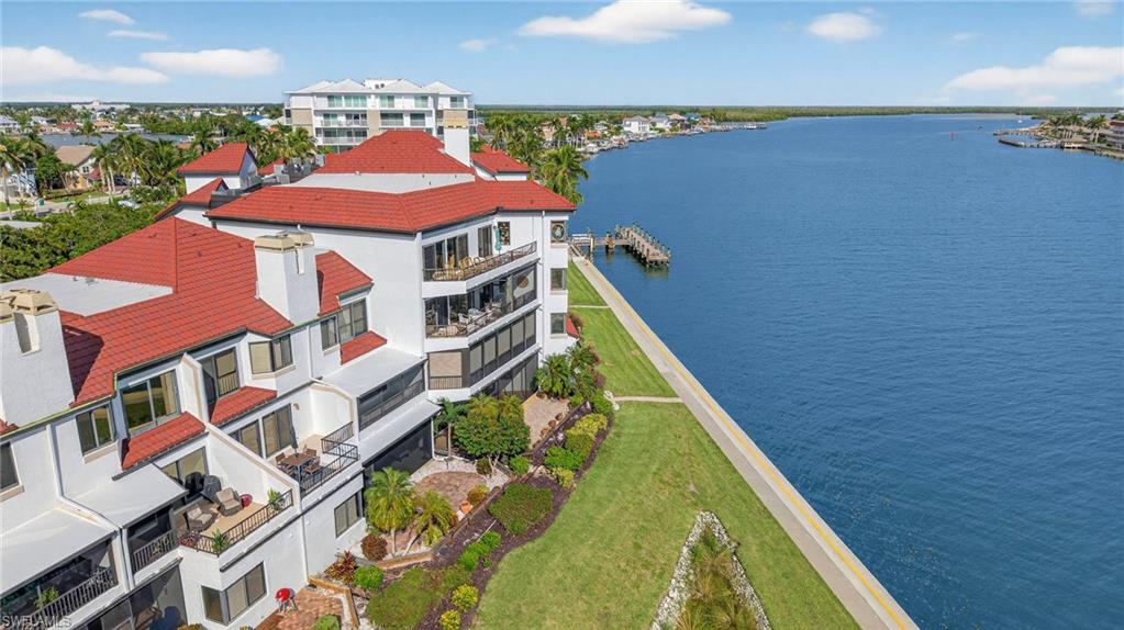 111 La Peninsula Boulevard, Unit 111 Naples, FL 34113 - Photo 32 of 33 an aerial view of residential houses with outdoor space