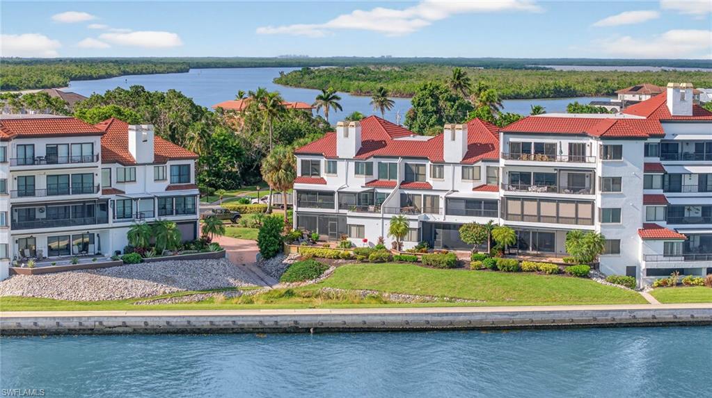 111 La Peninsula Boulevard, Unit 111 Naples, FL 34113 - Photo 33 of 33 a view of houses with swimming pool and city view