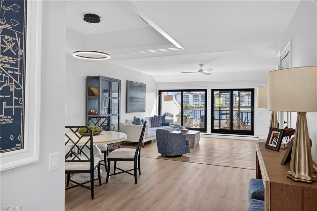 111 La Peninsula Boulevard, Unit 111 Naples, FL 34113 - Photo 6 of 33 a living room with furniture and a large window