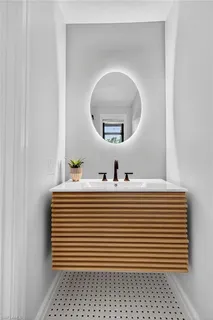 a white and white bathroom with a sink