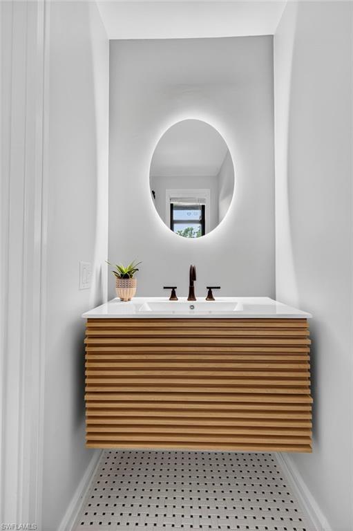 111 La Peninsula Boulevard, Unit 111 Naples, FL 34113 - Photo 7 of 33 a white and white bathroom with a sink