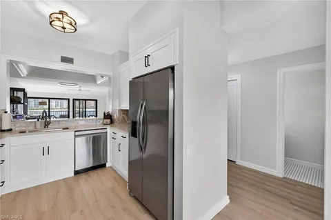 a kitchen with stainless steel appliances granite countertop a refrigerator and a sink