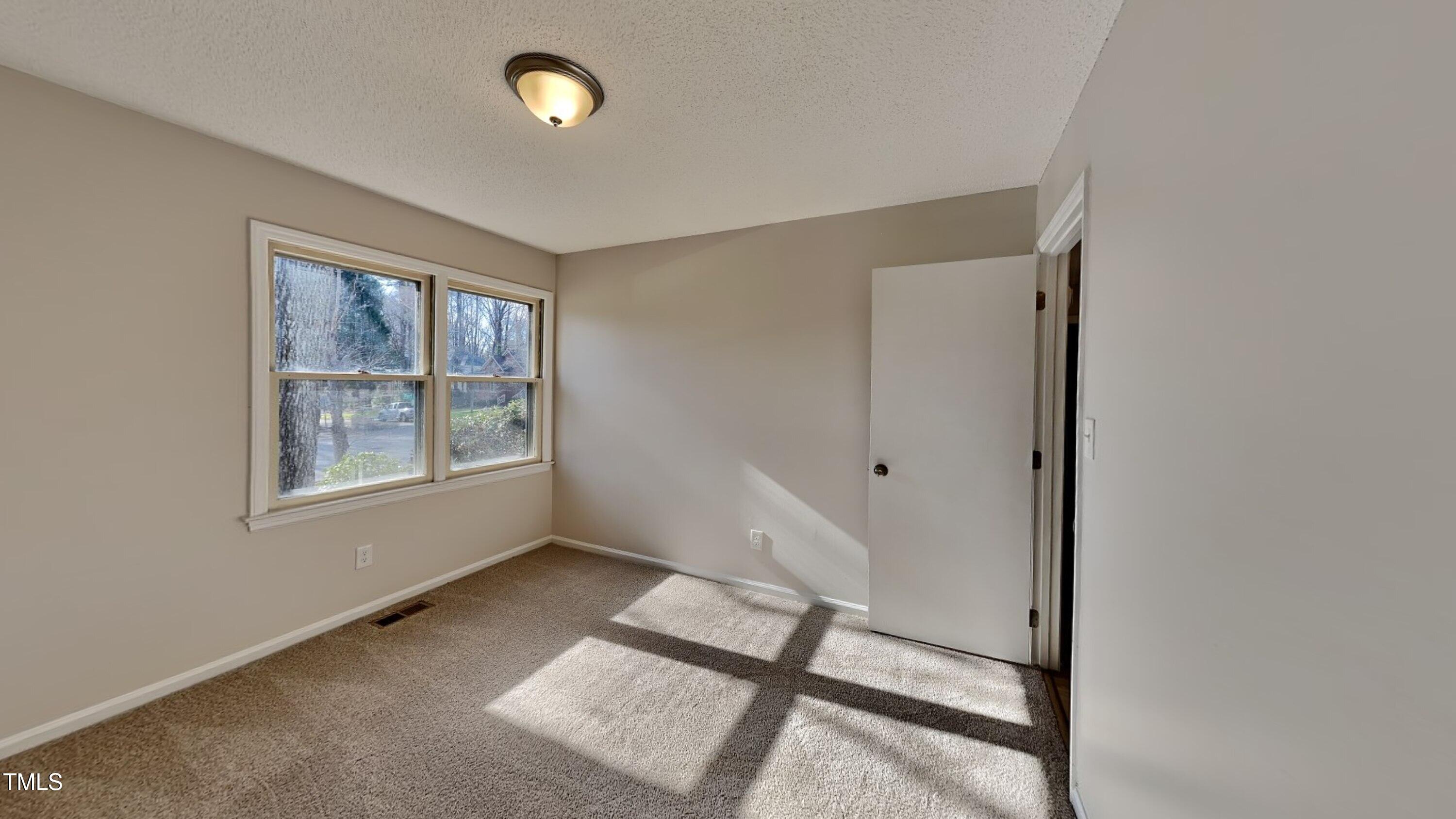 1921 Port Royal Road Raleigh, NC 27609 - Photo 12 of 18 a view of an empty room with a window