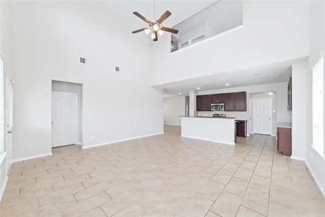 a view of a kitchen with a sink and a refrigerator
