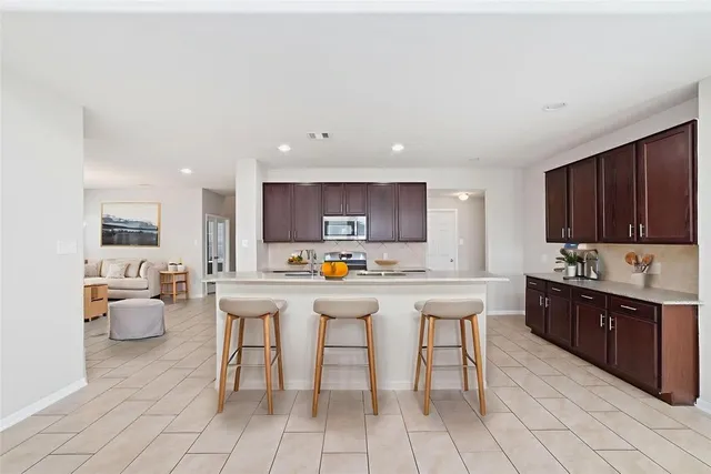 a kitchen with cabinets a sink and appliances
