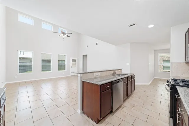a kitchen with granite countertop a sink and a stove