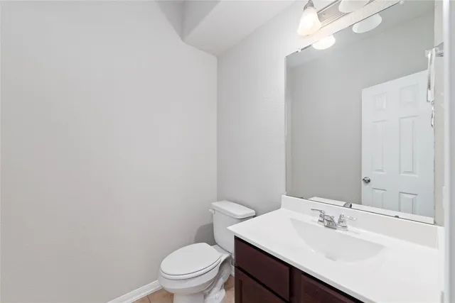 a bathroom with a sink a toilet and mirror