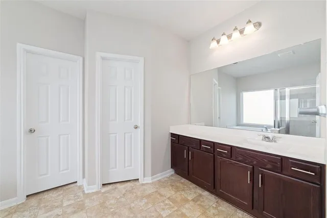 a bathroom with a double vanity sink and a mirror