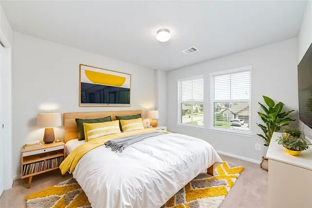 a bedroom with a bed and a couch