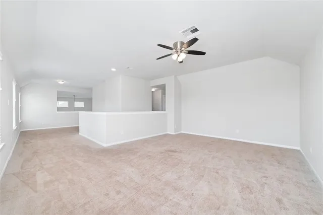 a view of an empty room with a kitchen