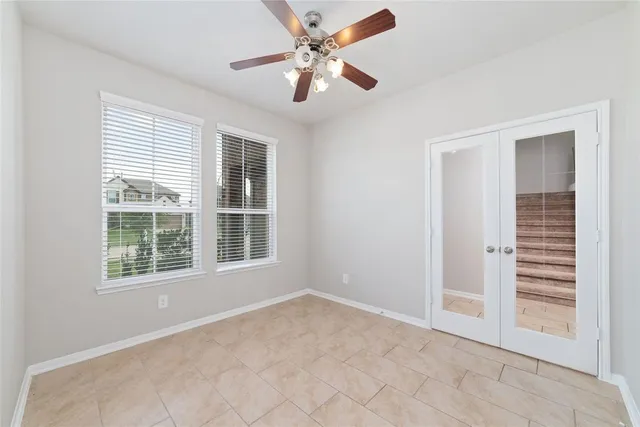 an empty room with closet and windows