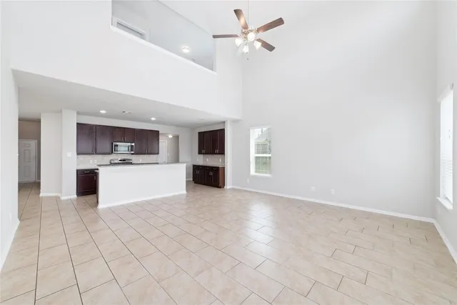a view of kitchen with granite countertop cabinets and white appliances