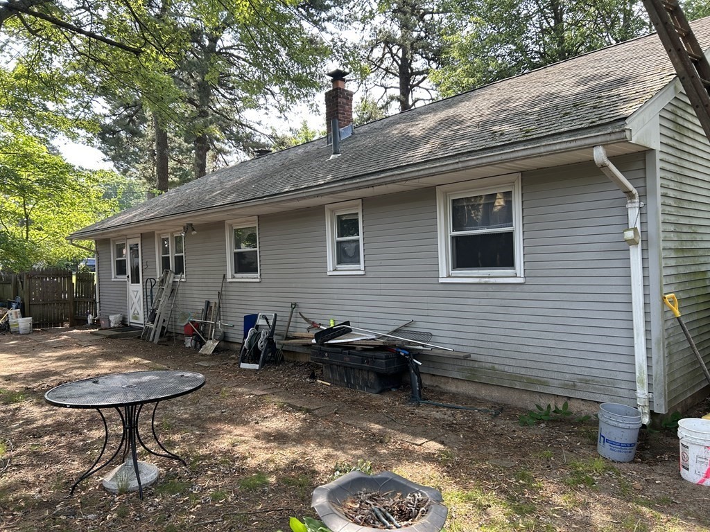 48 Emerald Road Springfield, MA 01119 - Photo 10 of 10 a backyard of a house with barbeque oven table and chairs