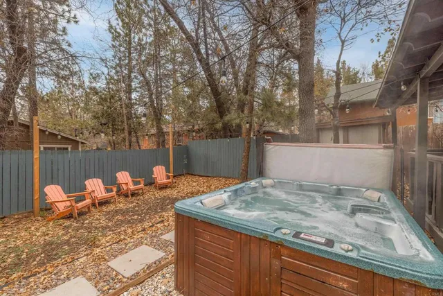 a backyard of a house with table and chairs