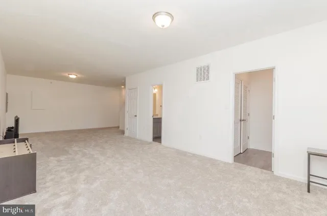a bathroom with a granite countertop sink toilet and vanity