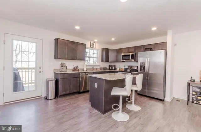 a patio with yard and outdoor seating