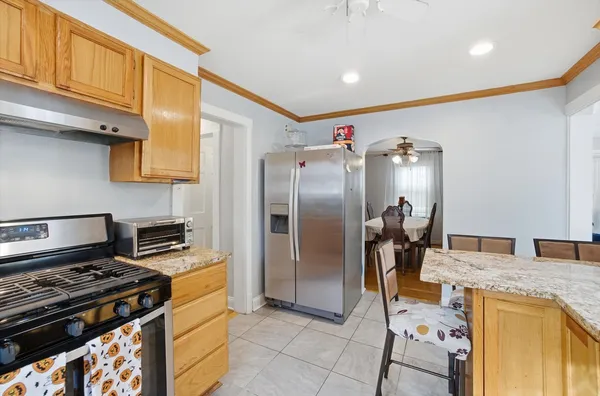 a kitchen with stainless steel appliances granite countertop a refrigerator and a stove top oven