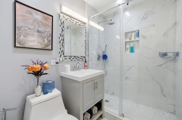 a bathroom with a sink mirror toilet and vanity