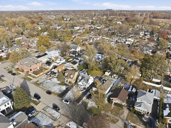 an aerial view of a residential houses with yard