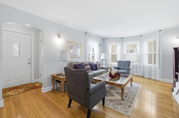 a living room with furniture and a wooden floor