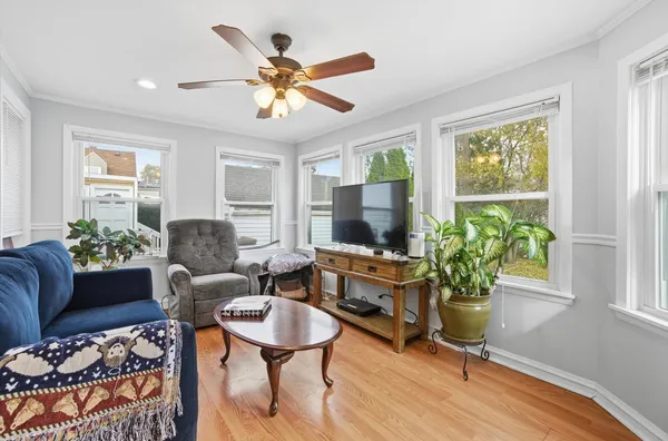 a living room with furniture potted plant and a window
