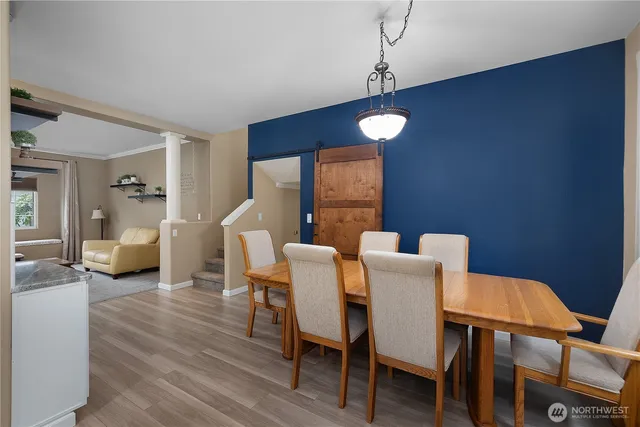 a view of a dining room with furniture and wooden floor