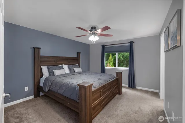 a bed sitting in a bedroom next to a window