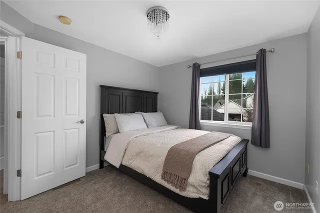 a bedroom with a large bed and a window