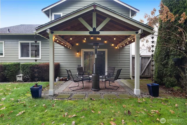 a view of a house with backyard porch and sitting area