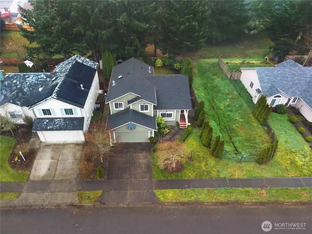 an aerial view of residential houses with outdoor space and street view