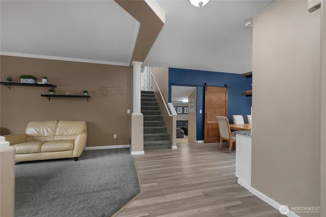 a living room with furniture and stairs
