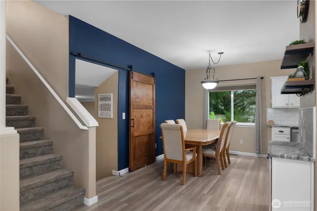 a view of a dining room with furniture window and wooden floor