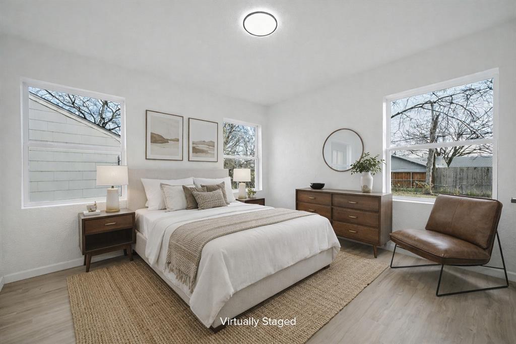 11446 Lippitt Avenue Dallas, TX 75218 - Photo 21 of 26 a bedroom with a bed a couch and dresser