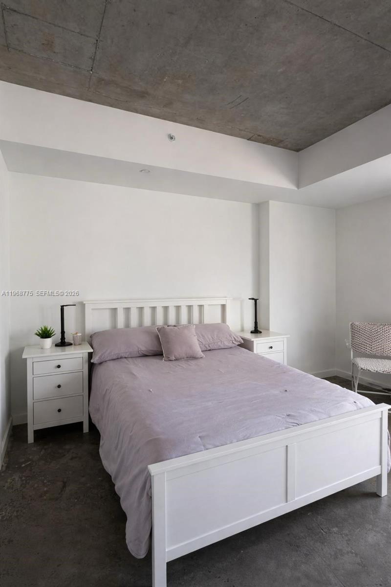 151 Southeast 1st Street, Unit 909 Miami, FL 33131 - Photo 1 of 29 a bedroom with a bed and a couch